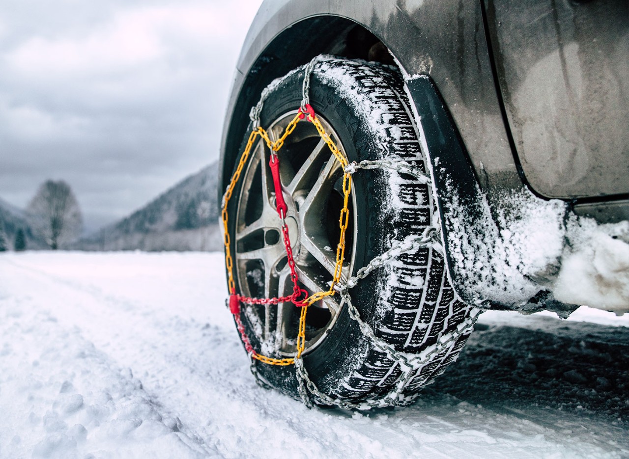 un pneu de voiture auquel sont fixées des chaînes à neige