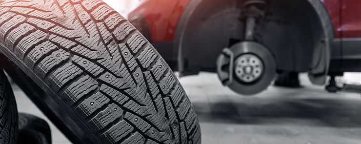 Concept car wheel service, changing winter tire on machine at station